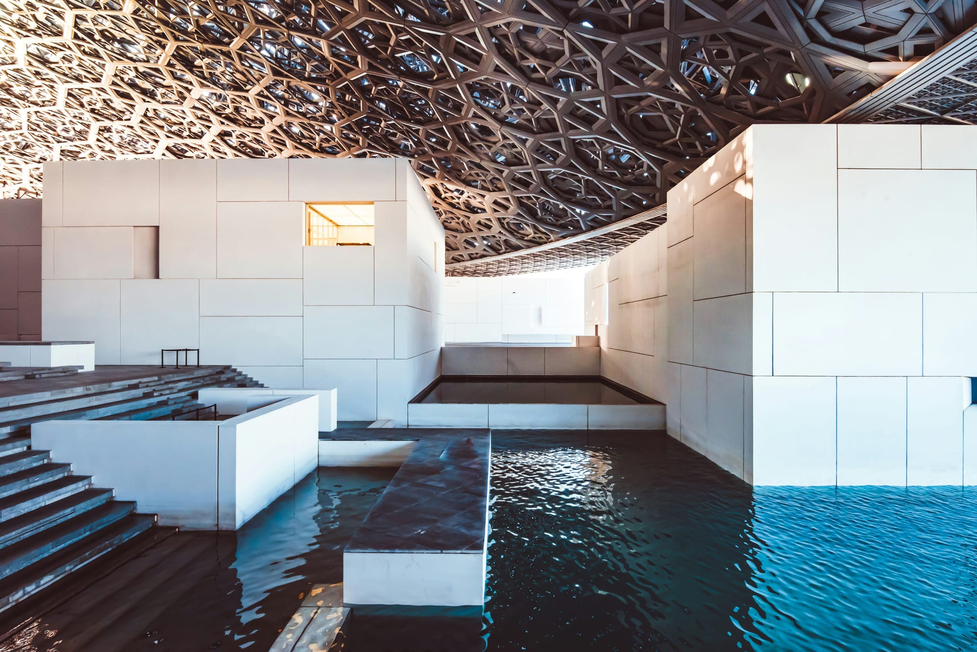  Interior view of the Louvre Abu Dhabi featuring open galleries with high ceilings and natural light.
