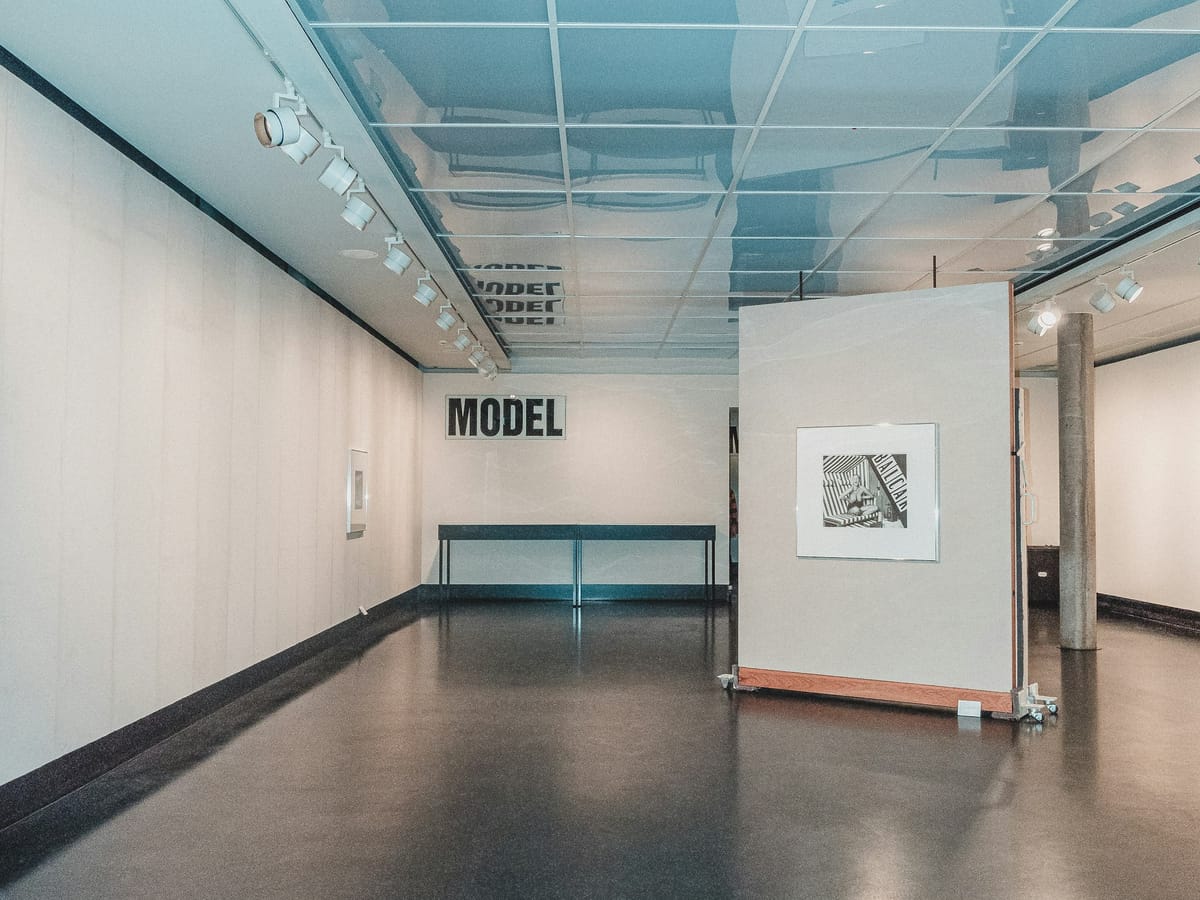 A small gallery preparing for a phased exhibition opening during a congested art season.