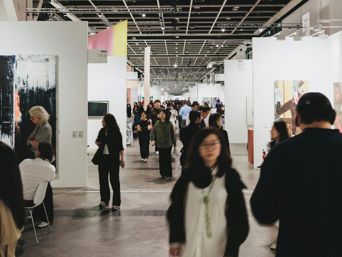 Visitors moving through a major art event during a congested opening weekend with rapid audience turnover.