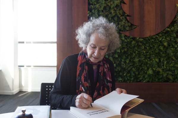Margaret Atwood signing a book, The Handmaid’s Tale