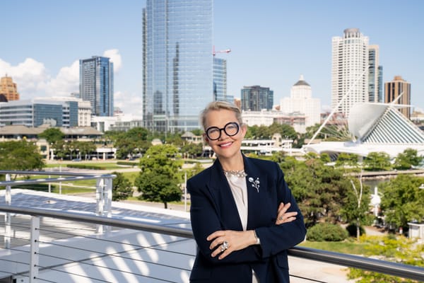 Kim Sajet, new director of the Milwaukee Art Museum, standing in a museum balcony