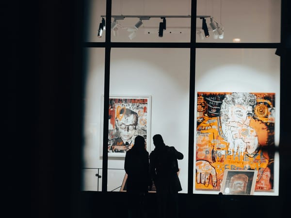 Contemporary gallery exterior with visitors viewing artworks