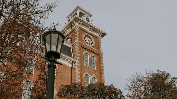 Exterior view of the University of Arkansas campus in Fayetteville, showing the red-brick architecture of Fulbright College