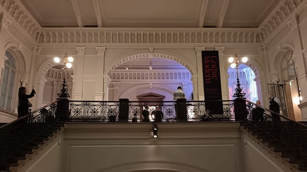 Entrance hall of Ateneum Art Museum during Gothic Modern at Ateneum, with statue leading visitors into the exhibition