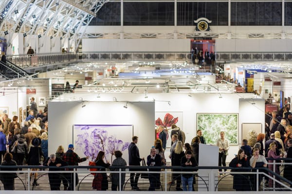 Visitors circulate through the London Art Fair 2025 at the Business Design Centre in Islington during early preview hours.