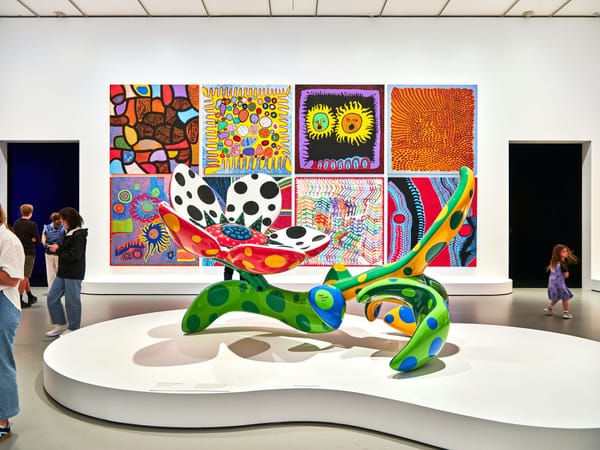 Visitors moving through multiple galleries during a densely scheduled opening weekend in a major art city.