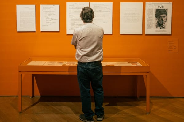 Archival provenance documents and valuation files arranged on a desk, reflecting the fragile role of documentation in contemporary art authentication.