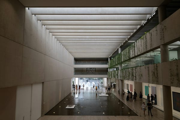 Minimal architectural interior with layered corridors and converging lines, suggesting consolidated authority and structured passage.