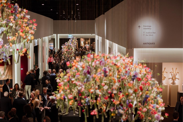 Visitors walking through TEFAF Maastricht’s carpeted aisles at MECC.